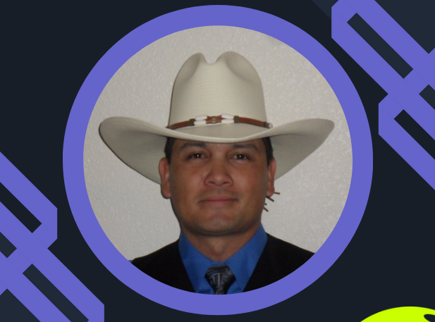 A man in a cowboy hat and suit.